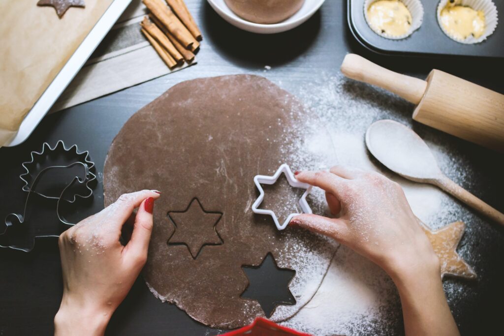 Person making stars using cookie cutter