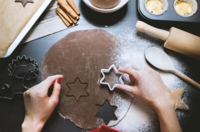 Person making stars using cookie cutter