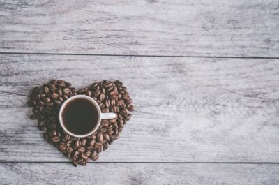 Heart made of coffee beans on desk