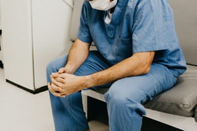 Healthcare worker wearing mask and sitting