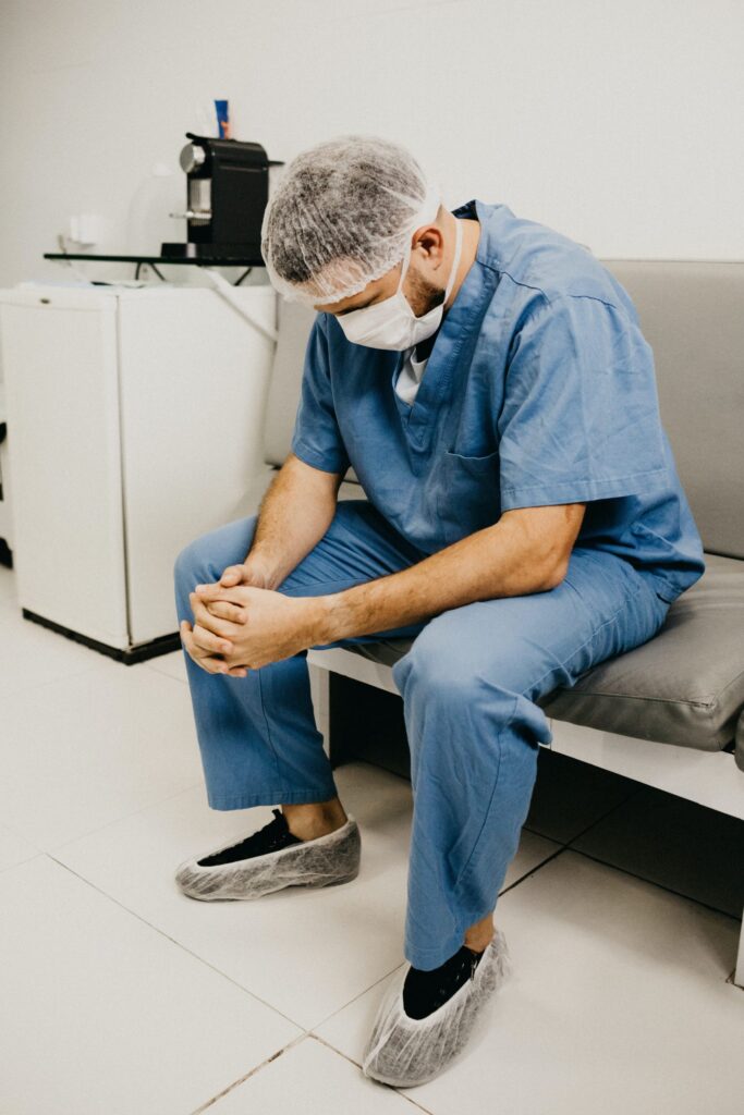 Healthcare worker wearing mask and sitting