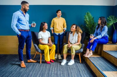 Office workers talking together in meeting room