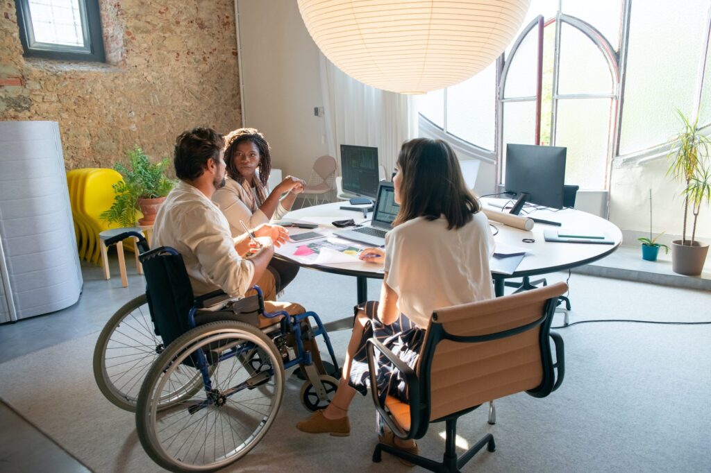 Group of office workers collaborating around table