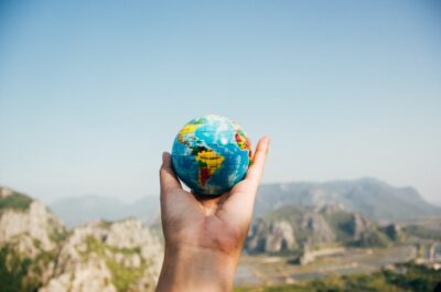 Hand holding a miniature globe