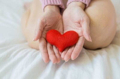 Hands holding small felt heart