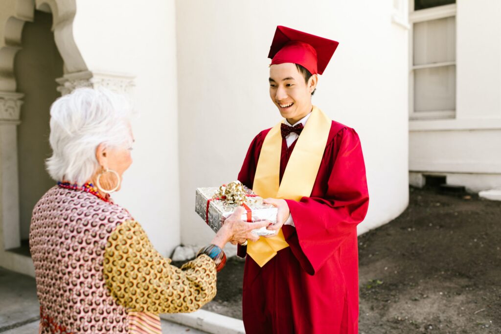 Graduate receiving gift from grandparent