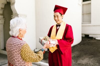 Graduate receiving gift from grandparent