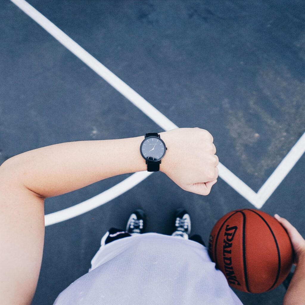Person on basketball court checking watch