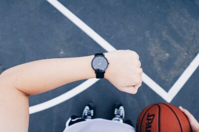 Person on basketball court checking watch