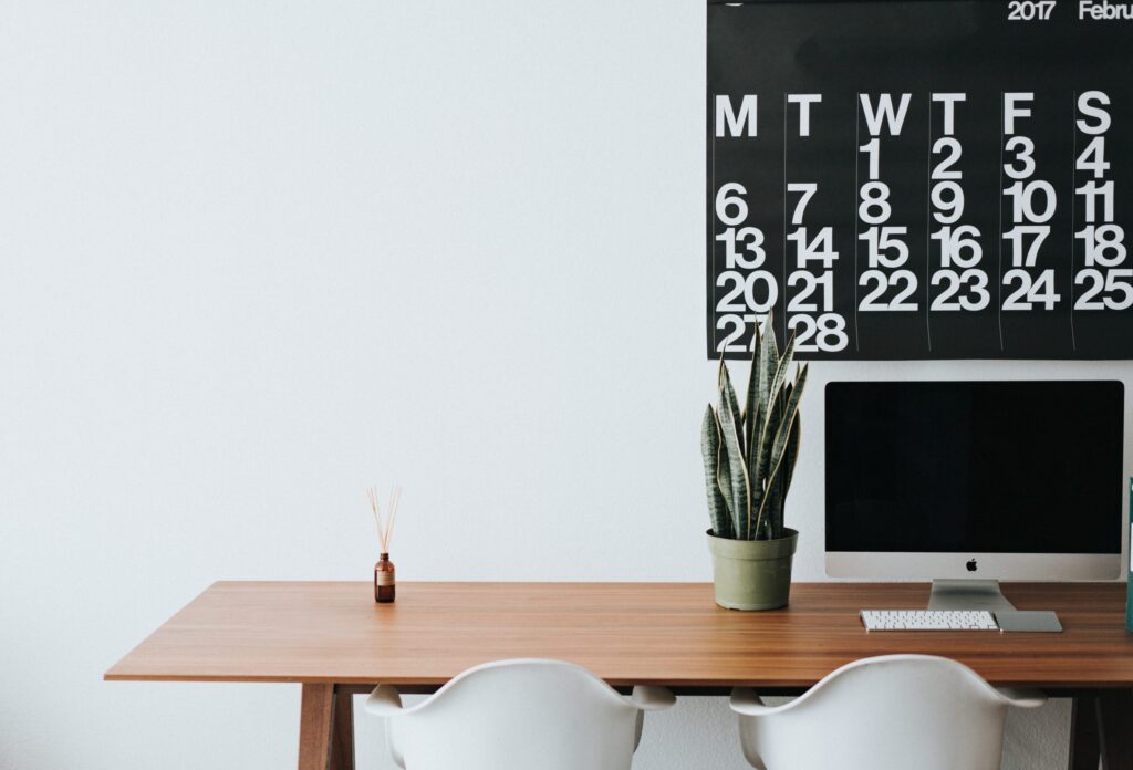 Desk with plant, monitor, and calendar