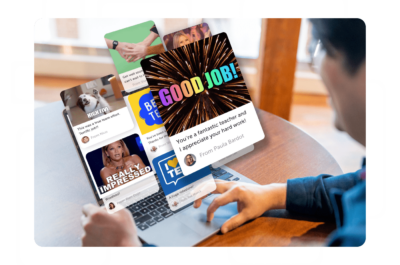 Person reading Kudoboard posts on laptop