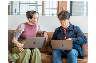 Two people working together on laptops