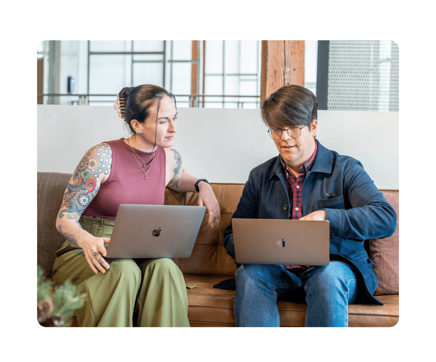 Two people working together on laptops