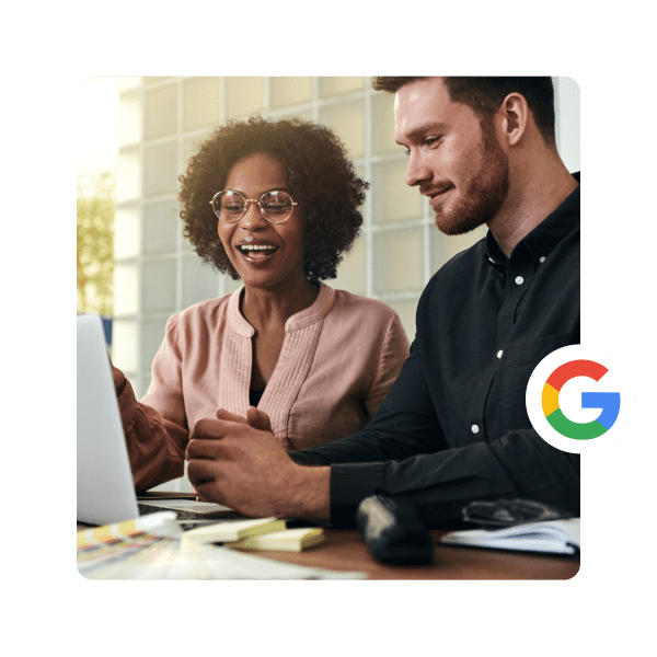 People looking at laptop and smiling with Google logo