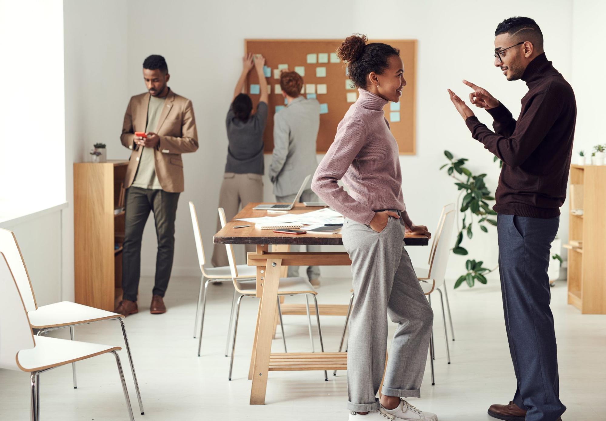 Man talking to woman in office meeting room