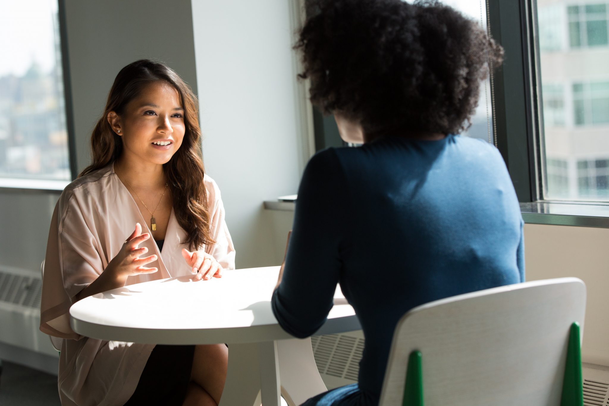 Two people talking together at table