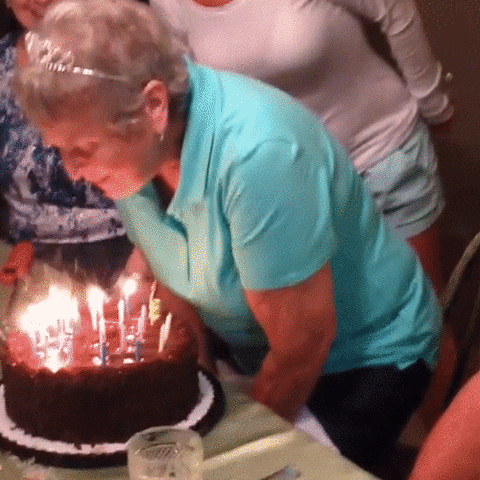 Grandma blowing out candles