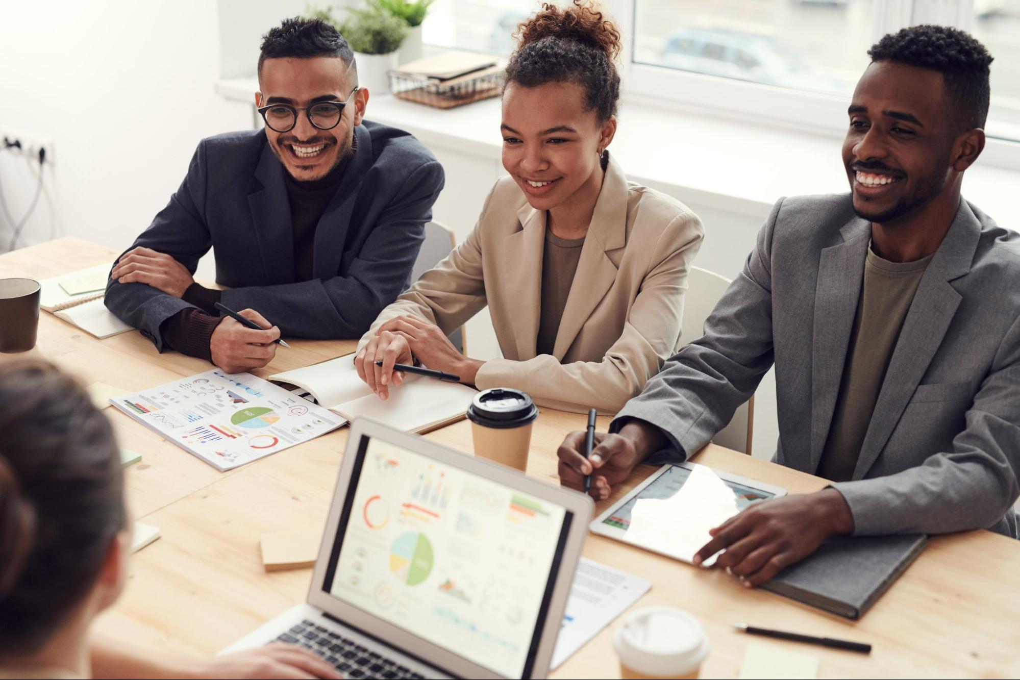 Group of coworkers talking and smiling together