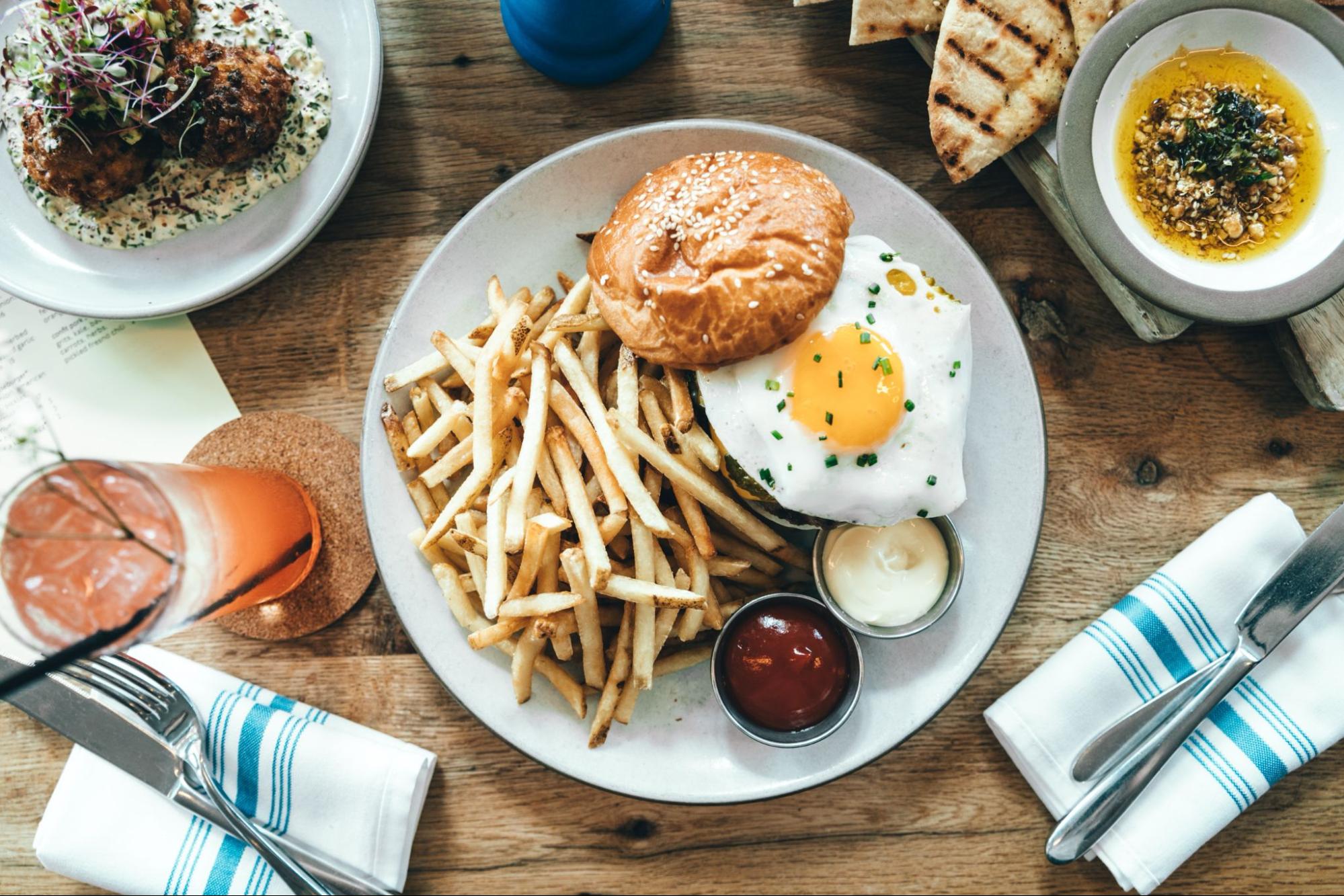 Burger with egg and fries on a plate