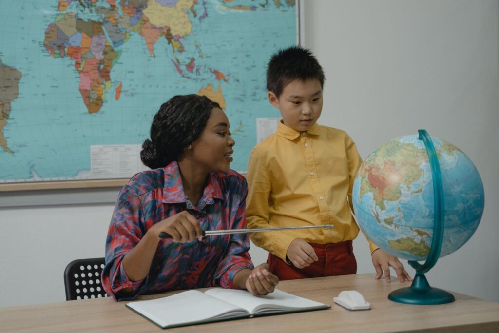 Teacher working with student at desk