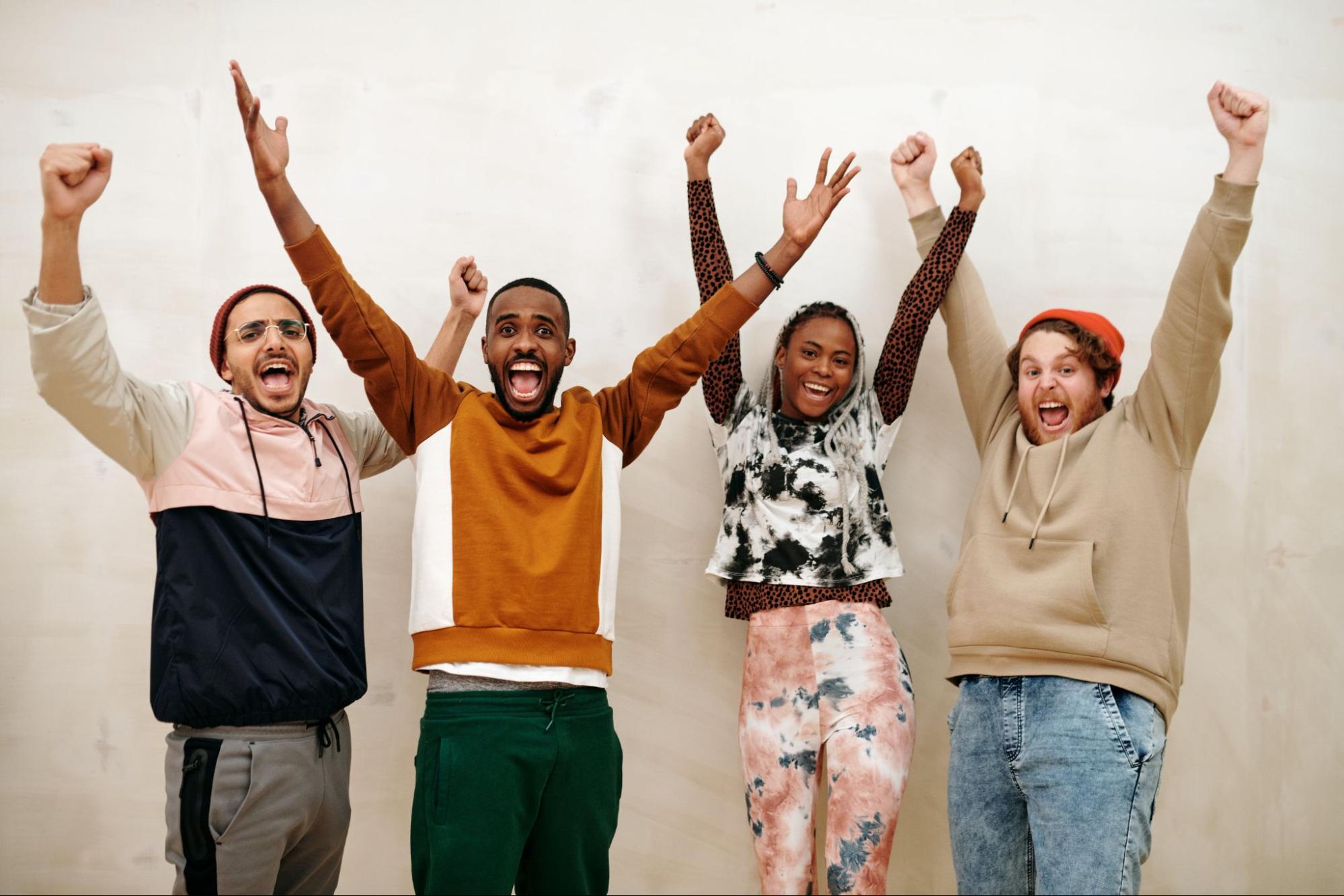 People celebrating with arms in air