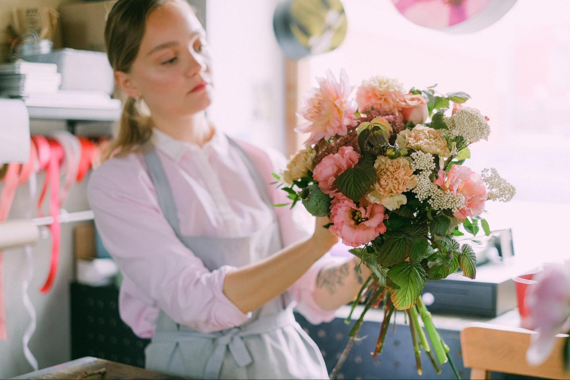 Person making a floral bouquet
