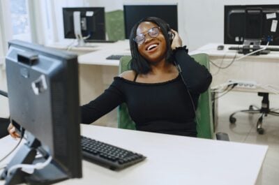 Person laughing with computer