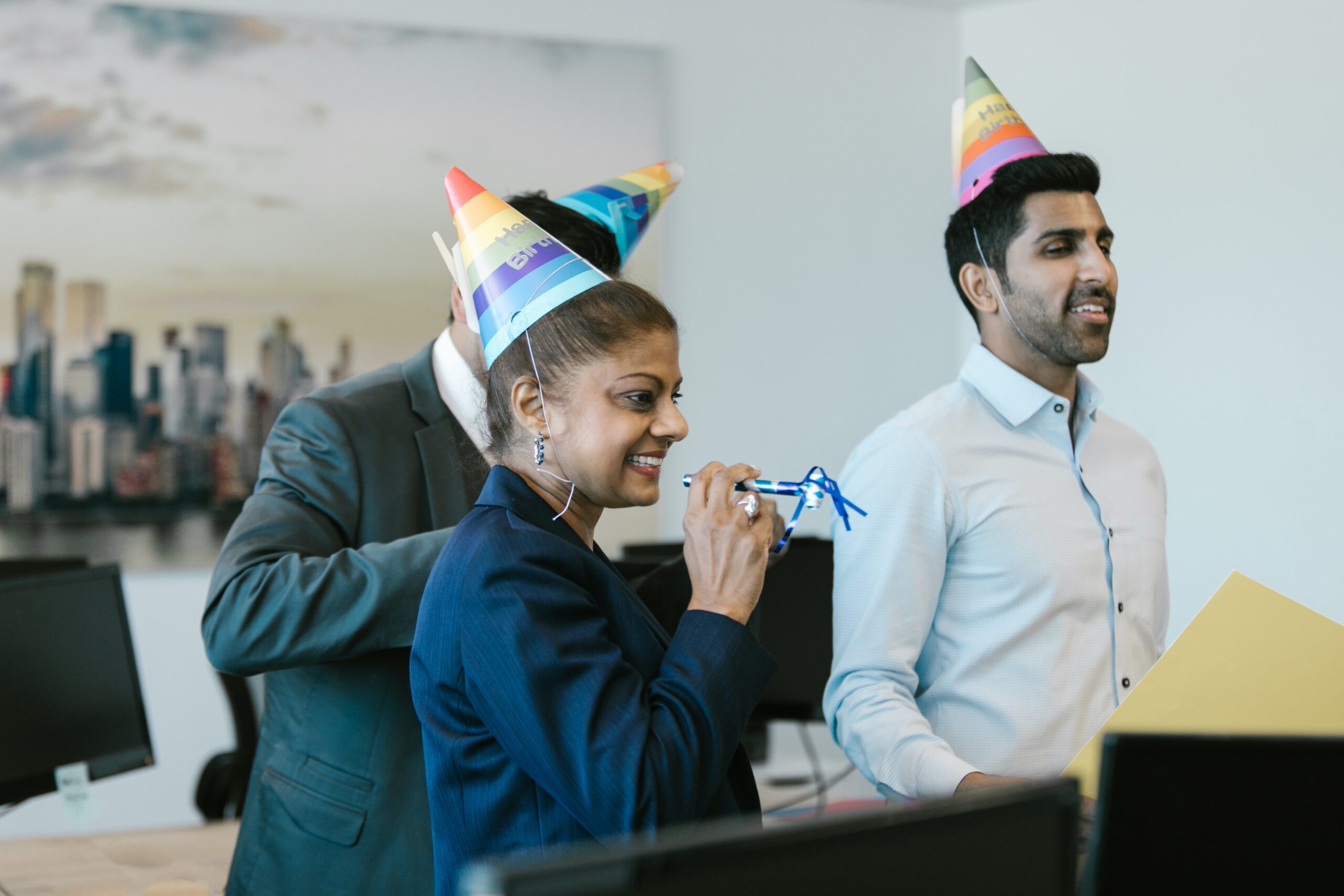 People wearing party hats in office
