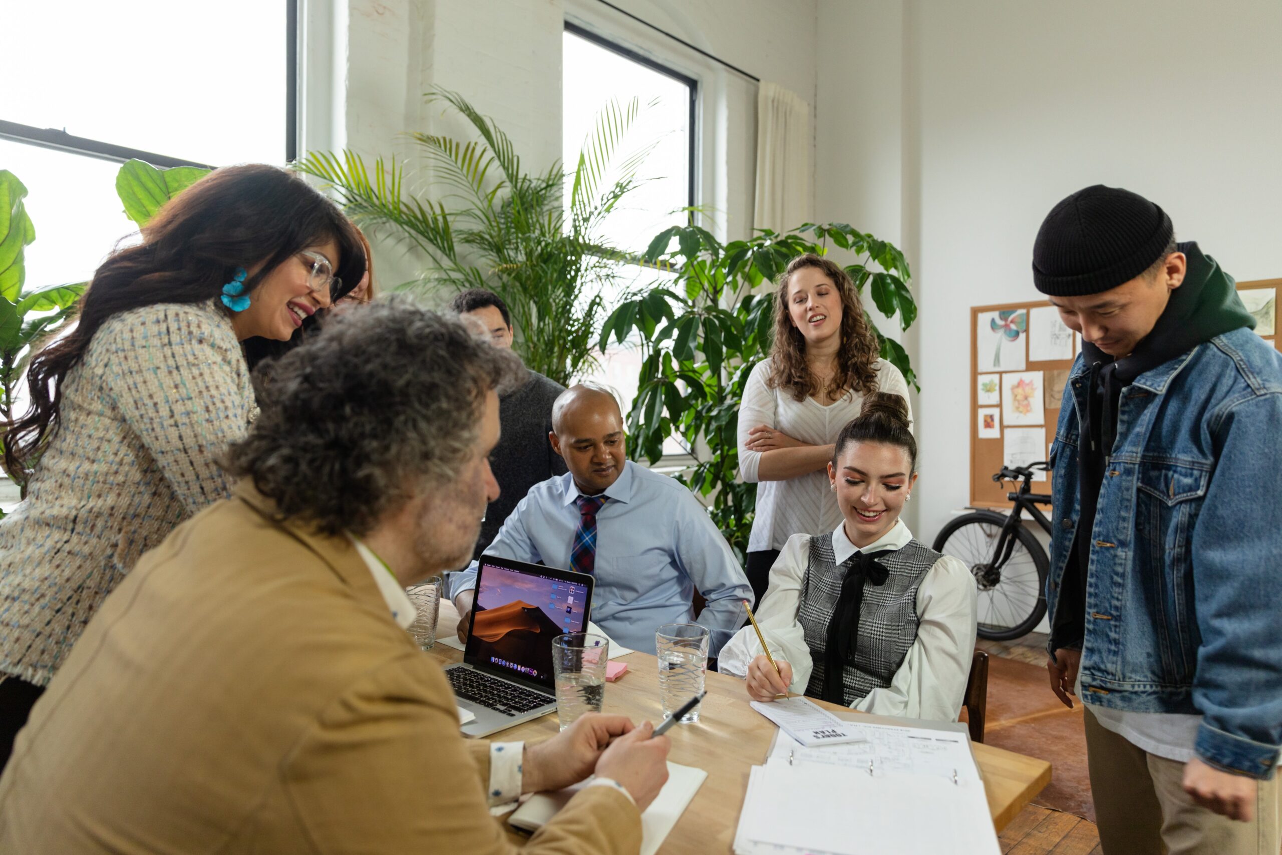 Smiling people standing around office