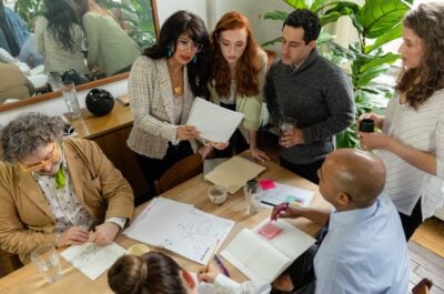 People looking at document around table