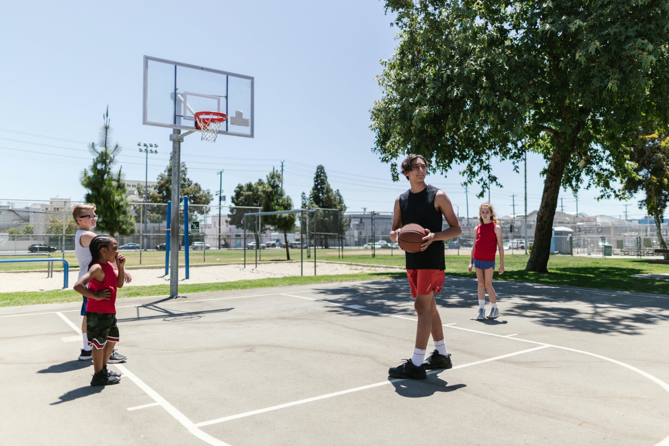 Basketball coach working with kids on the court