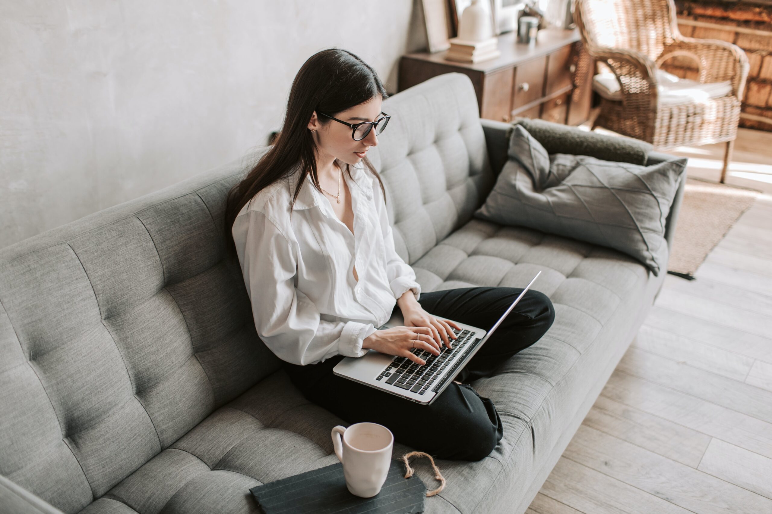 Woman working on laptop on couch