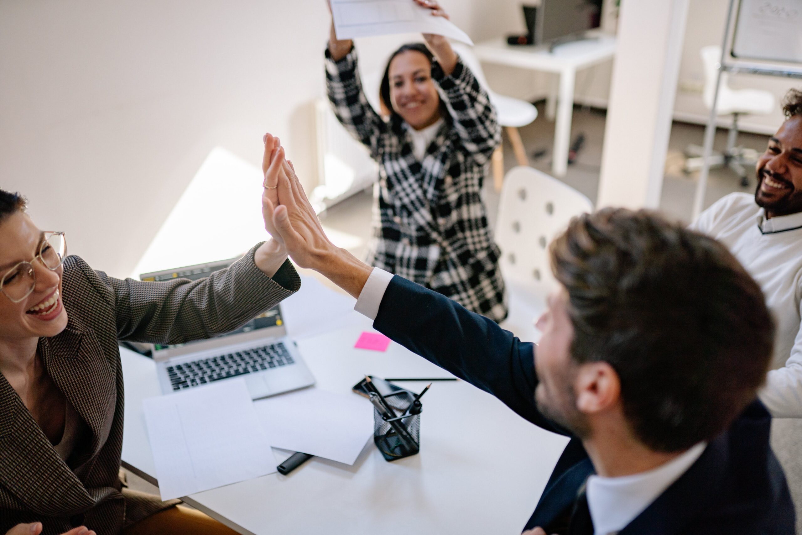 Group of coworkers celebrating in meeting room