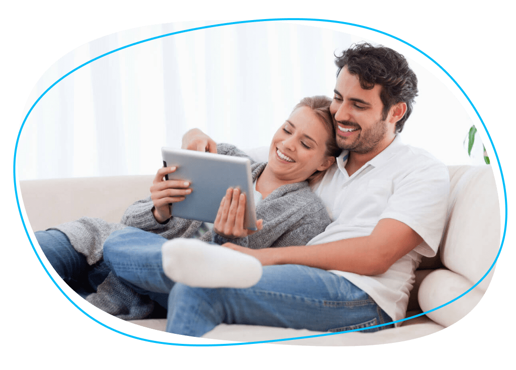 Couple smiling and looking at tablet together