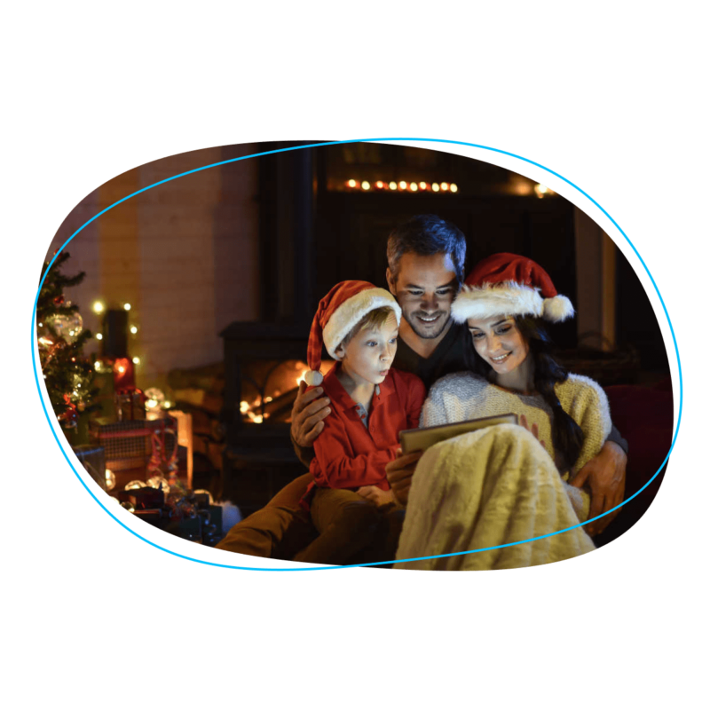Family in Santa hats looking at tablet