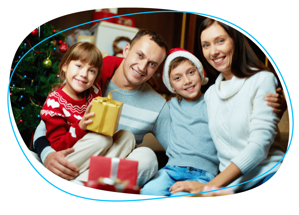 Family in Santa hats smiling for camera