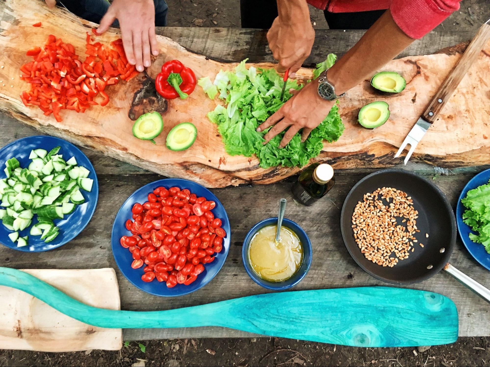 Person preparing a meal by chopping vegetables