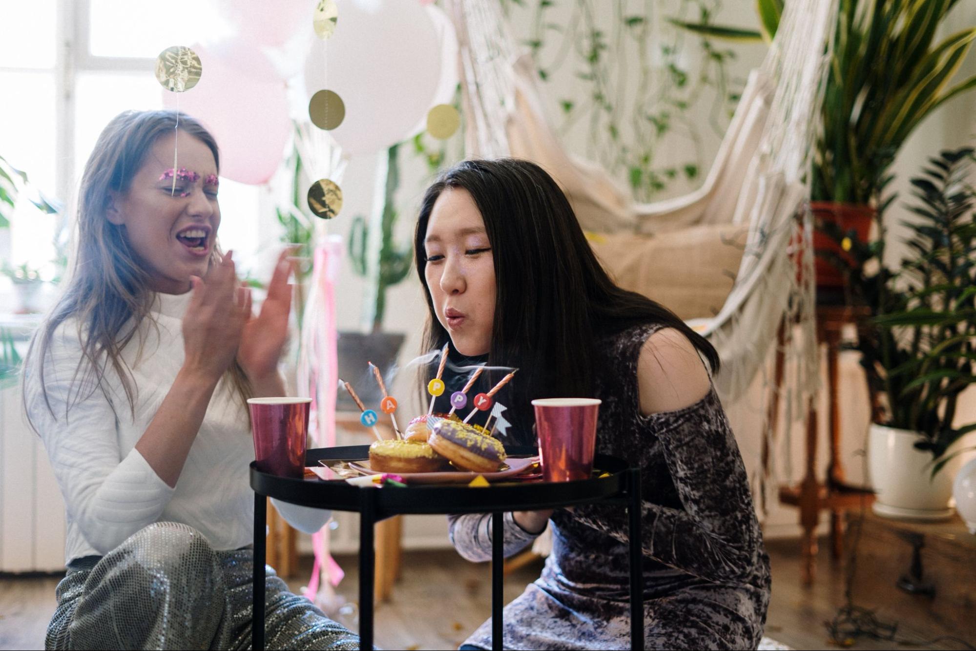 Friend blowing out candles at a birthday party