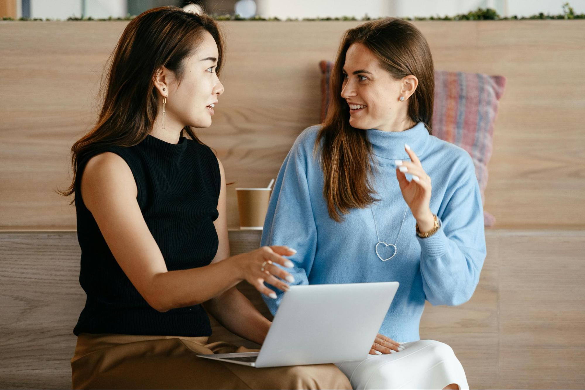 Two colleagues working together on a laptop