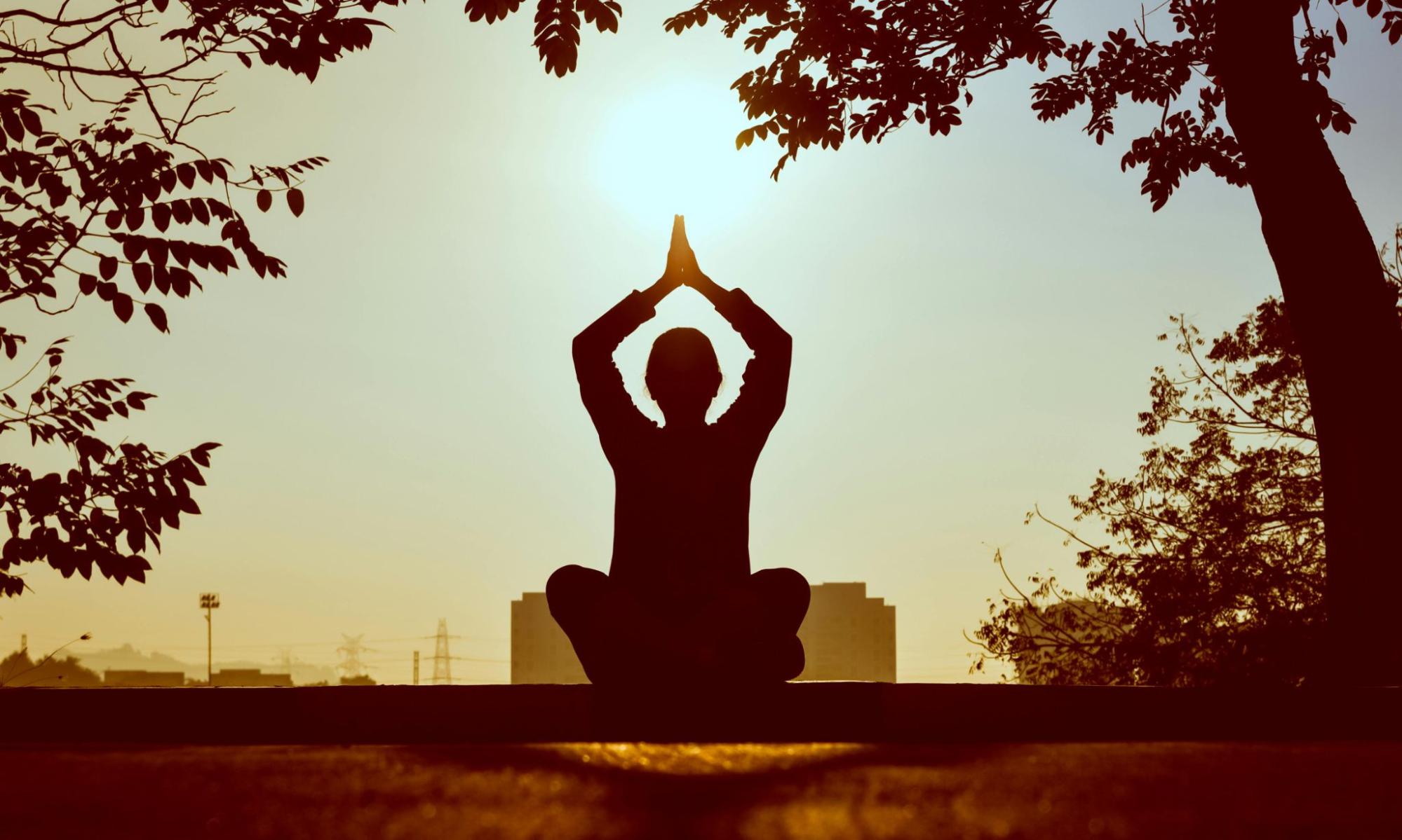 Person doing a yoga position in the sun