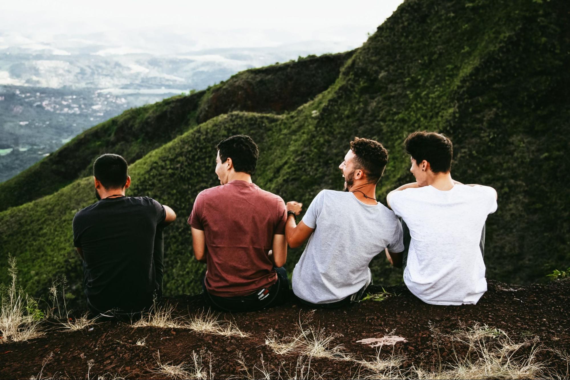 Friends sitting together and laughing outside