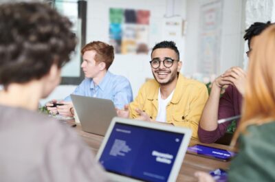 Employees interacting together at meeting table