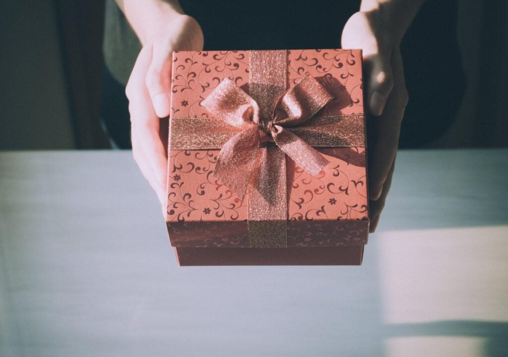 Person handing wrapped retirement present