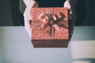 Person handing wrapped retirement present