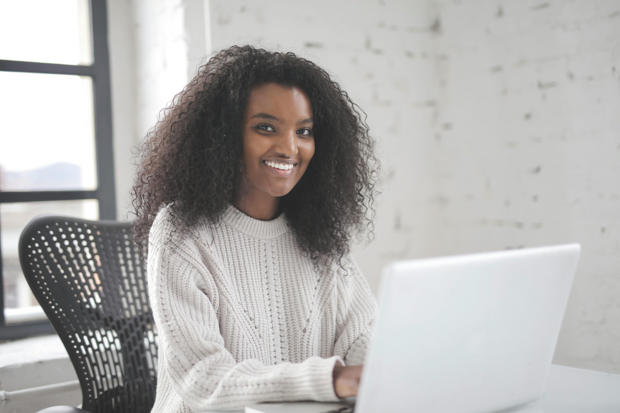 Employee on computer smiling