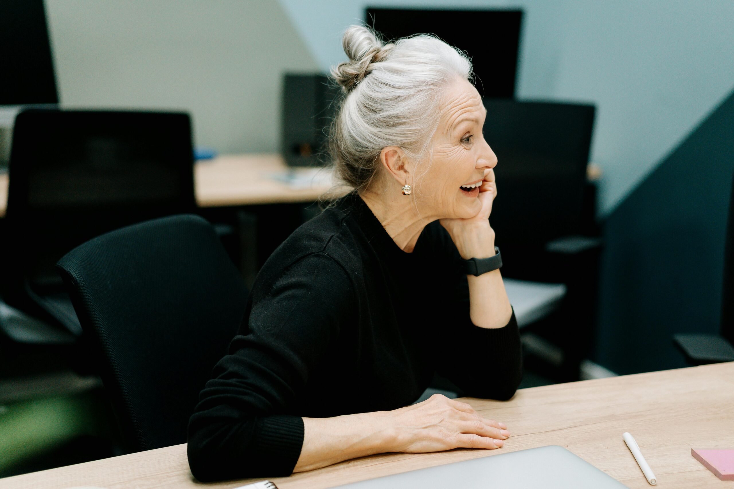 Older employee laughing after receiving thanks