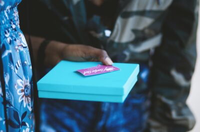 Person receiving a gift card with box