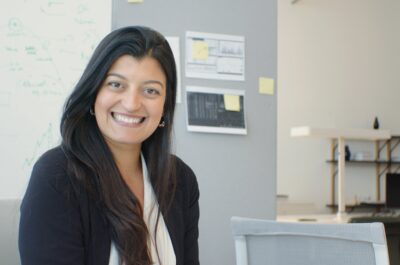 Human resources employee sitting at desk and smiling