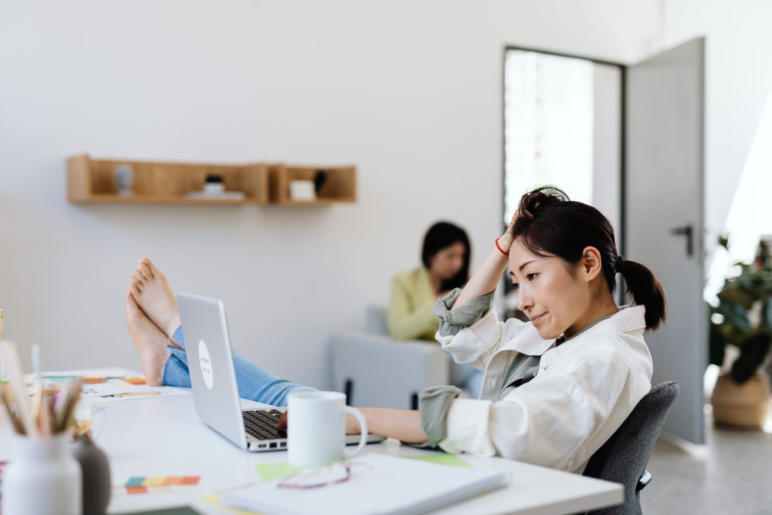 Disheveled employee with feet up on desk and no shoes