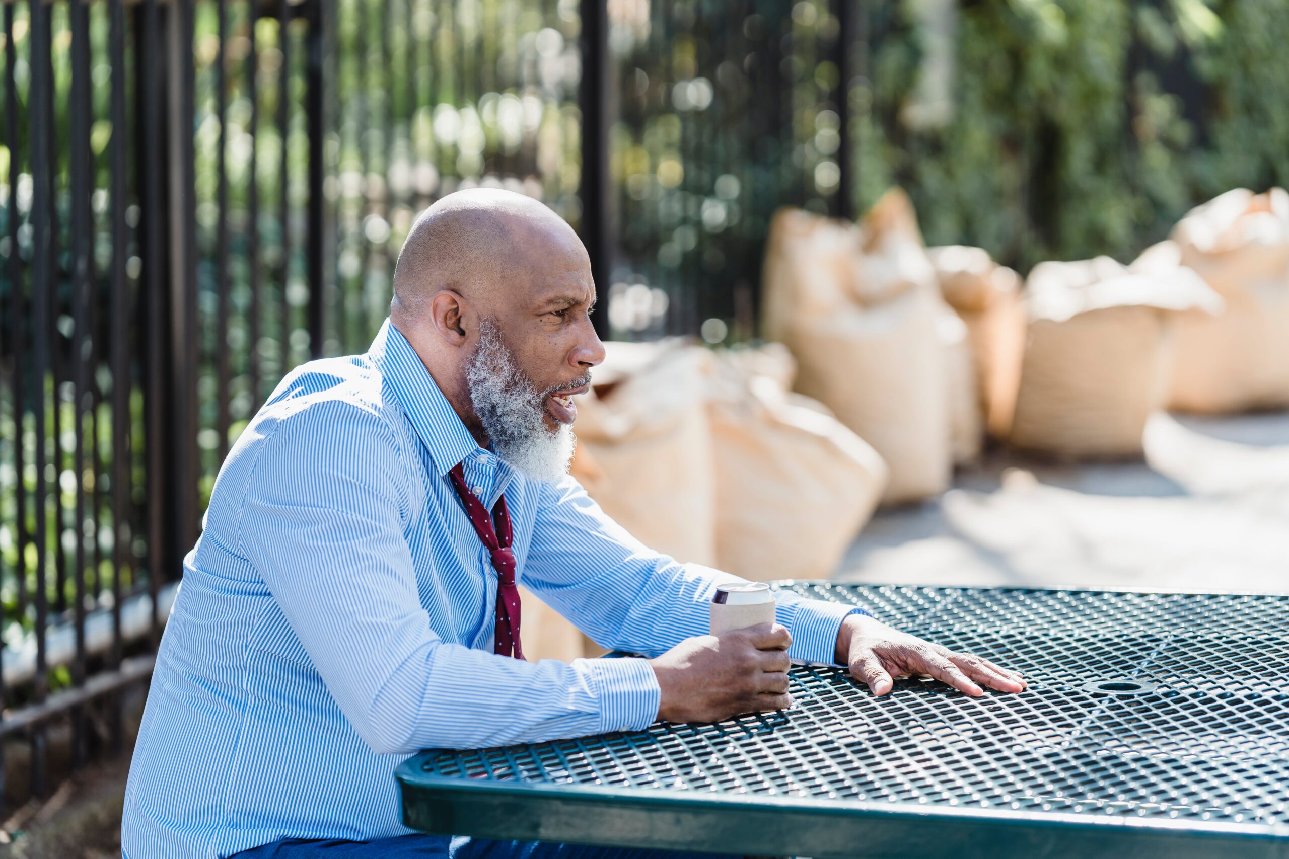 Employee sitting alone on a park bench